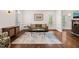 Bright living room showcasing hardwood floors, neutral walls, large windows, and comfortable furnishings at 2000 Katesbridge Ln, Raleigh, NC 27614