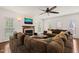 Bright living room with a fireplace, large sectional sofa, and multiple windows that flood the space with natural light at 2000 Katesbridge Ln, Raleigh, NC 27614