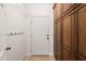 Mudroom with built-in storage cabinets and a door to the exterior at 2000 Katesbridge Ln, Raleigh, NC 27614