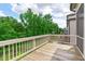 Wooden back deck with white railing overlooking lush greenery and trees at 2036 Amy Grace Ct, Fuquay Varina, NC 27526
