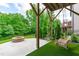 Backyard with an outdoor fire pit and porch swing surrounded by green grass at 2036 Amy Grace Ct, Fuquay Varina, NC 27526