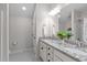 Bathroom featuring double vanity, granite countertop, and black-and-white tile flooring at 2036 Amy Grace Ct, Fuquay Varina, NC 27526