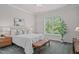 Bright bedroom with a queen-size bed, neutral decor, and a large window offering ample natural light at 2036 Amy Grace Ct, Fuquay Varina, NC 27526