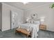 Bedroom with ensuite bath featuring a queen-size bed, neutral decor, and a large window at 2036 Amy Grace Ct, Fuquay Varina, NC 27526