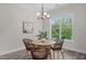 Cozy dining room with a wooden table, wicker chairs, and natural light from the large window at 2036 Amy Grace Ct, Fuquay Varina, NC 27526