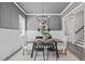 Elegant dining room with modern chandelier, wainscoting, and stylish table setting at 2036 Amy Grace Ct, Fuquay Varina, NC 27526