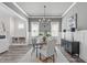 Bright dining room with stylish furnishings, wainscoting, and ample natural light at 2036 Amy Grace Ct, Fuquay Varina, NC 27526