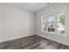 Bright, empty room with hardwood floors and a large window at 2036 Amy Grace Ct, Fuquay Varina, NC 27526