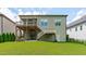 Back exterior with a two-story deck and a spacious lawn perfect for outdoor activities at 2036 Amy Grace Ct, Fuquay Varina, NC 27526