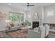 Cozy living room with fireplace, comfortable seating, and large windows overlooking greenery at 2036 Amy Grace Ct, Fuquay Varina, NC 27526