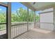 Screened porch with wood flooring overlooking lush greenery and a bright sky at 2036 Amy Grace Ct, Fuquay Varina, NC 27526