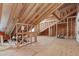 Unfinished attic space with exposed wooden beams and plywood flooring at 2036 Amy Grace Ct, Fuquay Varina, NC 27526