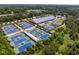 Aerial view of community tennis courts complex, surrounded by lush trees and landscaping at 205 Benwell Ct, Cary, NC 27519