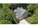 Aerial view of the home with a gray roof and a long driveway surrounded by trees at 205 Benwell Ct, Cary, NC 27519