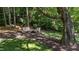A peaceful backyard space featuring outdoor seating and mature trees, perfect for relaxing at 205 Benwell Ct, Cary, NC 27519