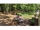 Secluded backyard retreat showcasing lush greenery, mature trees and a tranquil seating area at 205 Benwell Ct, Cary, NC 27519