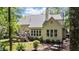 Scenic backyard featuring a deck, outdoor lighting, mature trees and lush landscaping at 205 Benwell Ct, Cary, NC 27519