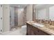 Bathroom showcasing a glass shower and tiled accent wall, accompanied by a stylish granite-topped vanity at 205 Benwell Ct, Cary, NC 27519
