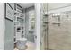 Stylish bathroom featuring custom built-ins, a modern toilet, and glass shower at 205 Benwell Ct, Cary, NC 27519