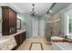 Bright bathroom with a soaking tub, shower, and dual vanities at 205 Benwell Ct, Cary, NC 27519