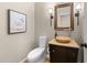 Stylish half bathroom featuring wood floors, modern fixtures, and unique decor at 205 Benwell Ct, Cary, NC 27519