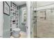 Contemporary bathroom with custom shelves next to the toilet and glass enclosed tiled shower at 205 Benwell Ct, Cary, NC 27519
