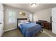 Bedroom with large windows allowing lots of natural light, a desk, and a ceiling fan at 205 Benwell Ct, Cary, NC 27519