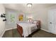 This bedroom has a comfy bed with light colored furnishings, a window with shutters, and a neutral color scheme at 205 Benwell Ct, Cary, NC 27519