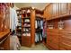 Walk-in closet has custom shelving, drawers, and hanging rods to maximize storage and organization at 205 Benwell Ct, Cary, NC 27519