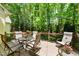 An outdoor deck featuring comfortable seating, perfect for relaxing and enjoying the wooded views at 205 Benwell Ct, Cary, NC 27519