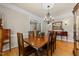 Elegant dining room featuring hardwood floors, a chandelier, and classic furnishings at 205 Benwell Ct, Cary, NC 27519