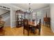 Formal dining room featuring hardwood floors, a classic chandelier, and elegant display cabinets at 205 Benwell Ct, Cary, NC 27519