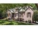 Charming brick home with manicured landscaping, shutters, and inviting front entrance at 205 Benwell Ct, Cary, NC 27519
