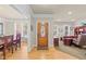 Inviting foyer featuring hardwood floors, front door with decorative window, and views into the dining room and office at 205 Benwell Ct, Cary, NC 27519