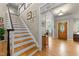 Inviting foyer featuring hardwood floors and stairs, with a view into the dining and living areas at 205 Benwell Ct, Cary, NC 27519