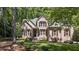 Charming brick home with manicured lawn, mature trees, and well-maintained landscaping at 205 Benwell Ct, Cary, NC 27519