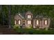 Beautiful brick home with well-maintained landscaping, wood shutters and covered front entrance at 205 Benwell Ct, Cary, NC 27519