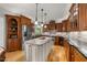 Spacious kitchen features a large island with granite countertops, stainless steel appliances and custom cabinetry at 205 Benwell Ct, Cary, NC 27519