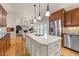 A bright kitchen with an island, seamlessly connecting to the living and dining areas at 205 Benwell Ct, Cary, NC 27519