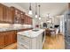 Spacious kitchen featuring a granite island, stainless steel appliances, and stylish backsplash at 205 Benwell Ct, Cary, NC 27519