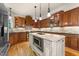 Spacious kitchen features custom cabinets, granite countertops, stainless steel appliances, and an island with a built-in microwave at 205 Benwell Ct, Cary, NC 27519