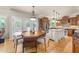 Bright kitchen featuring a central island, wood cabinets, stainless steel appliances, and a charming breakfast nook at 205 Benwell Ct, Cary, NC 27519