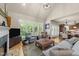 Bright and airy living room features hardwood floors, large windows, and comfortable seating at 205 Benwell Ct, Cary, NC 27519