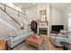 Inviting living room with a fireplace, comfortable seating, hardwood floors, and abundant natural light from large windows at 205 Benwell Ct, Cary, NC 27519