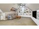 Cozy living room features a comfortable sofa, custom built-ins, and a ceiling fan at 205 Benwell Ct, Cary, NC 27519