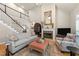 A cozy living room with a fireplace, plush seating, and a view of the home's staircase at 205 Benwell Ct, Cary, NC 27519
