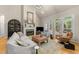 Bright living room featuring fireplace, comfortable seating, hardwood floors, and a vaulted ceiling at 205 Benwell Ct, Cary, NC 27519