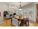 Spacious living room featuring fireplace, and large windows allowing plenty of natural light, with a dining area at 205 Benwell Ct, Cary, NC 27519