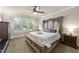 A luxurious main bedroom with a decorative headboard, ceiling fan, and plenty of natural light at 205 Benwell Ct, Cary, NC 27519