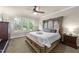 Spacious main bedroom with a tray ceiling, carpet flooring and elegant furnishings at 205 Benwell Ct, Cary, NC 27519